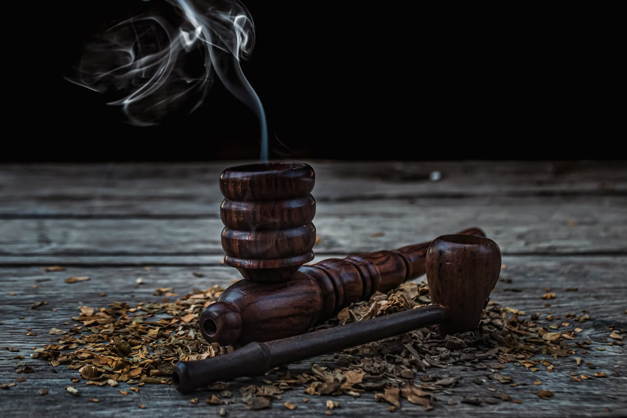 Traditional wooden smoking pipes with aromatic smoke in Varanasi, India setting.